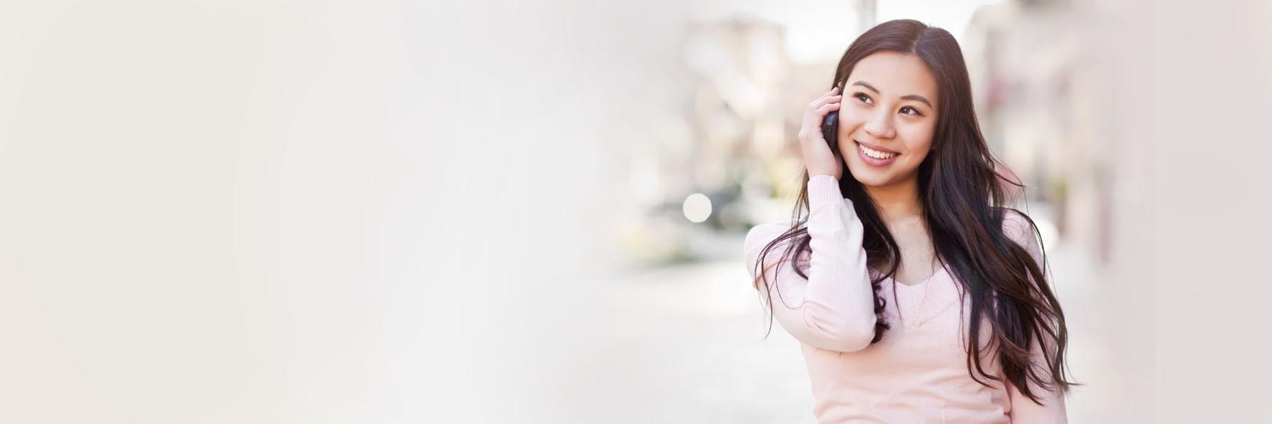 Woman smiling on the phone | cavities Vienna VA