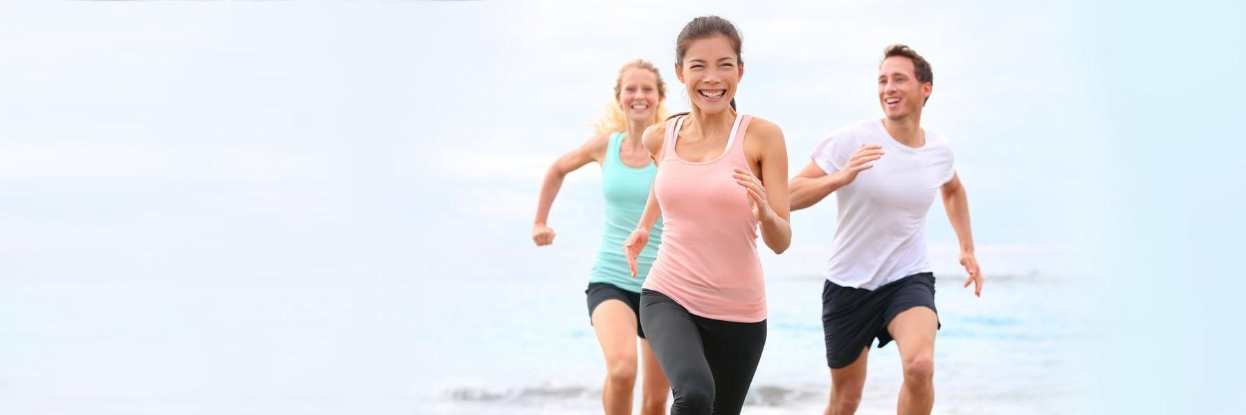 Friends running on the beach | Oral Health Vienna VA