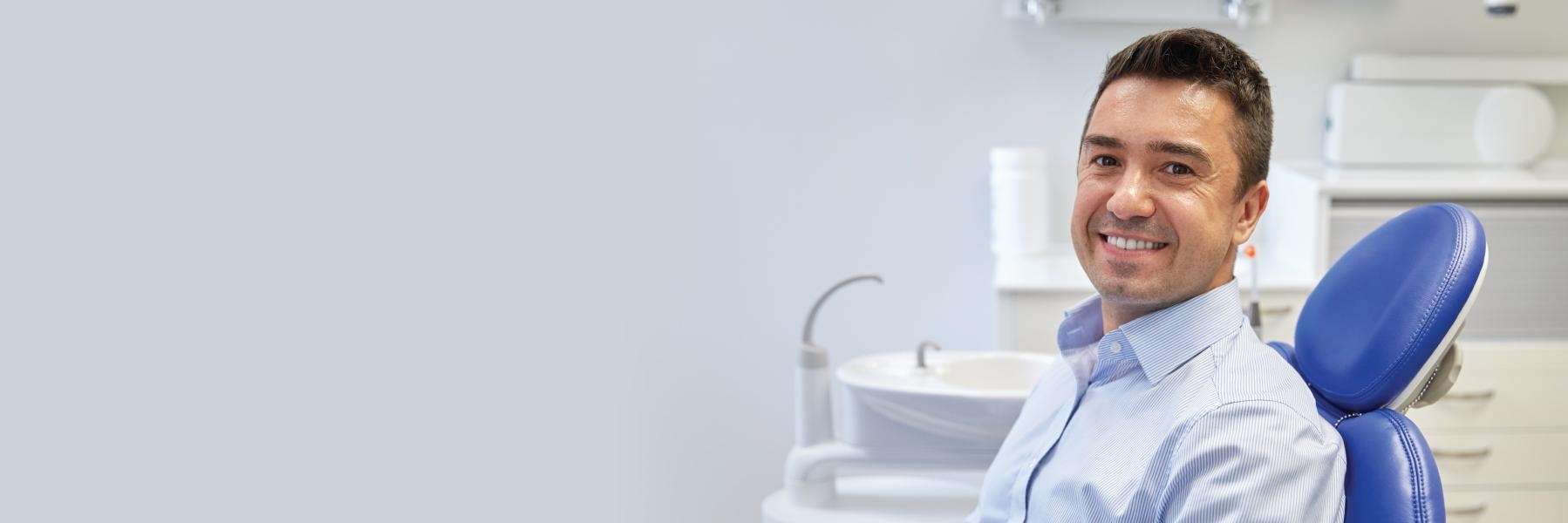 Smiling man in a dental chair, showcasing CEREC's comfort and efficiency in modern dentistry